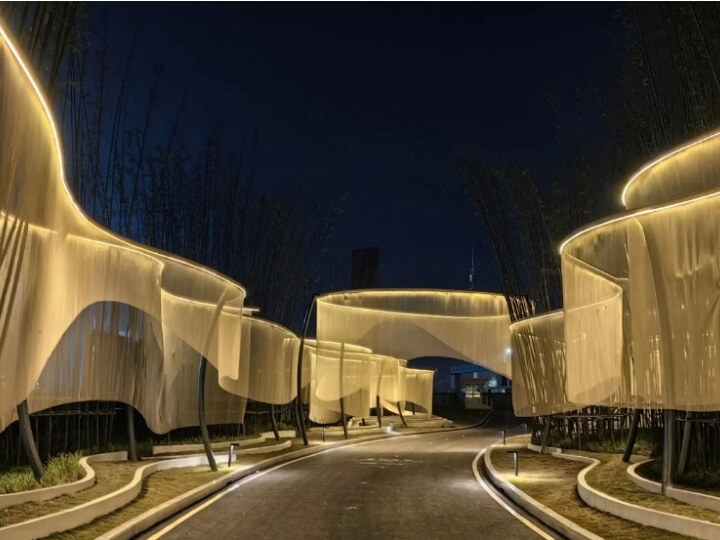 Panoramic view of metal mesh curtain installation at night from the walkway