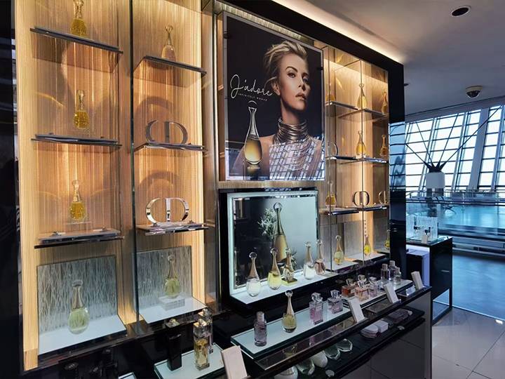 Dior's perfumes displayed on laminated glass shelves
