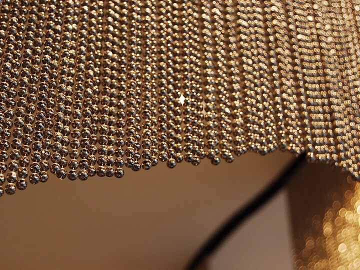 A detail of champagne-colored metal bead curtain.