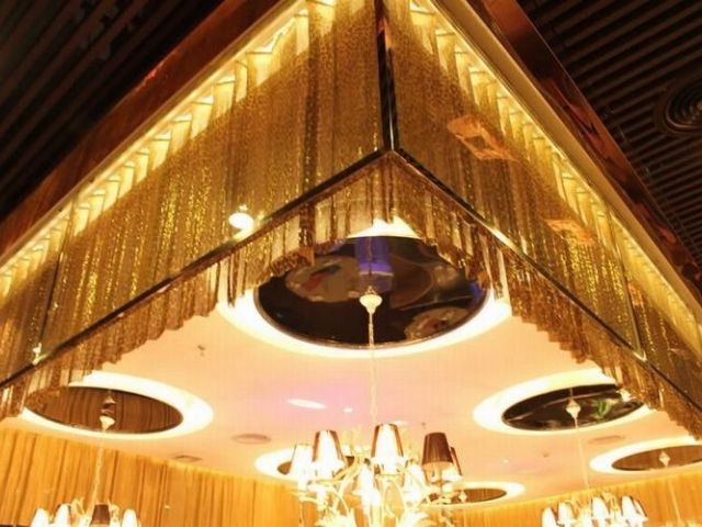 The ceiling is decorated with many hanging metallic fabric cloth.