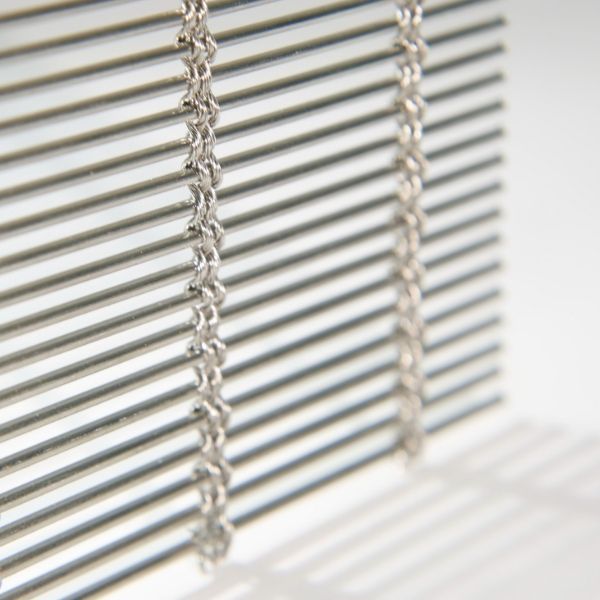 A vertically hanging woven wire drapery sample