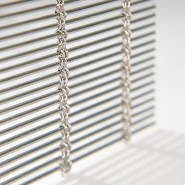 A vertically hanging woven wire drapery sample