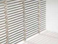 A vertically hanging woven wire drapery sample
